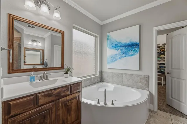 a white bath tub sitting next to a bathroom sink