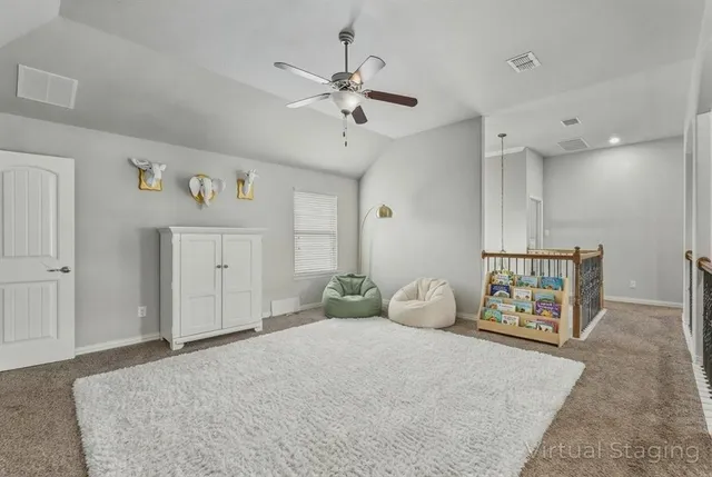 a bedroom with a bed and ceiling fan