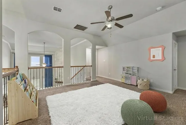 a bedroom with a bed a couch and a chandelier