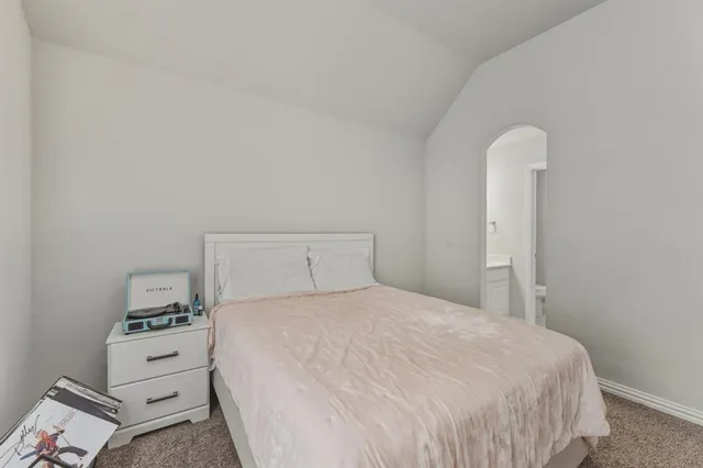 a bedroom with a bed and a night stand