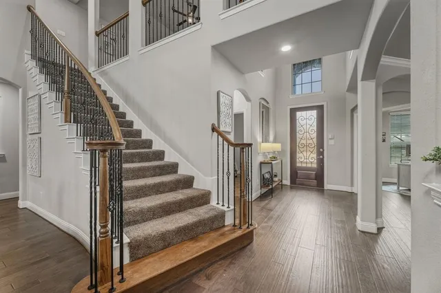 a view of entryway and hall with wooden floor