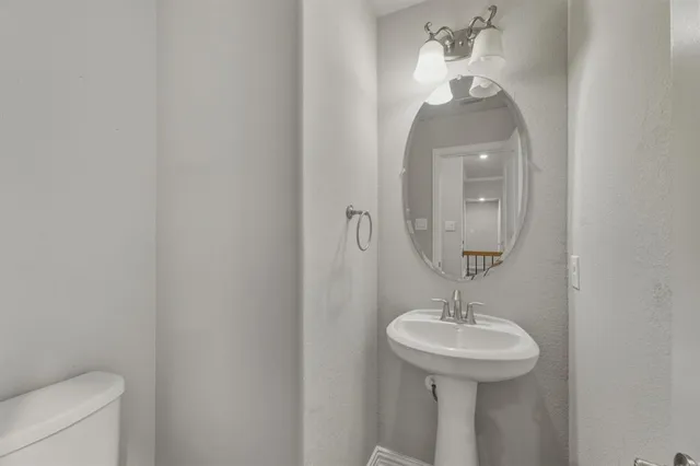 a kitchen with a refrigerator and a stove top oven
