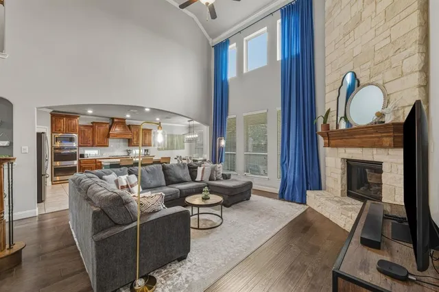a living room with furniture a fireplace and a flat screen tv