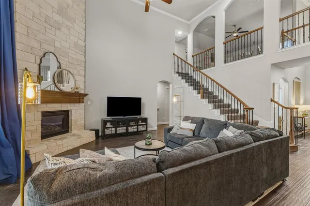 a living room with furniture a fireplace and a flat screen tv