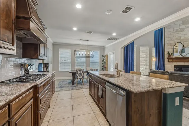 a kitchen with stainless steel appliances granite countertop a stove and a sink