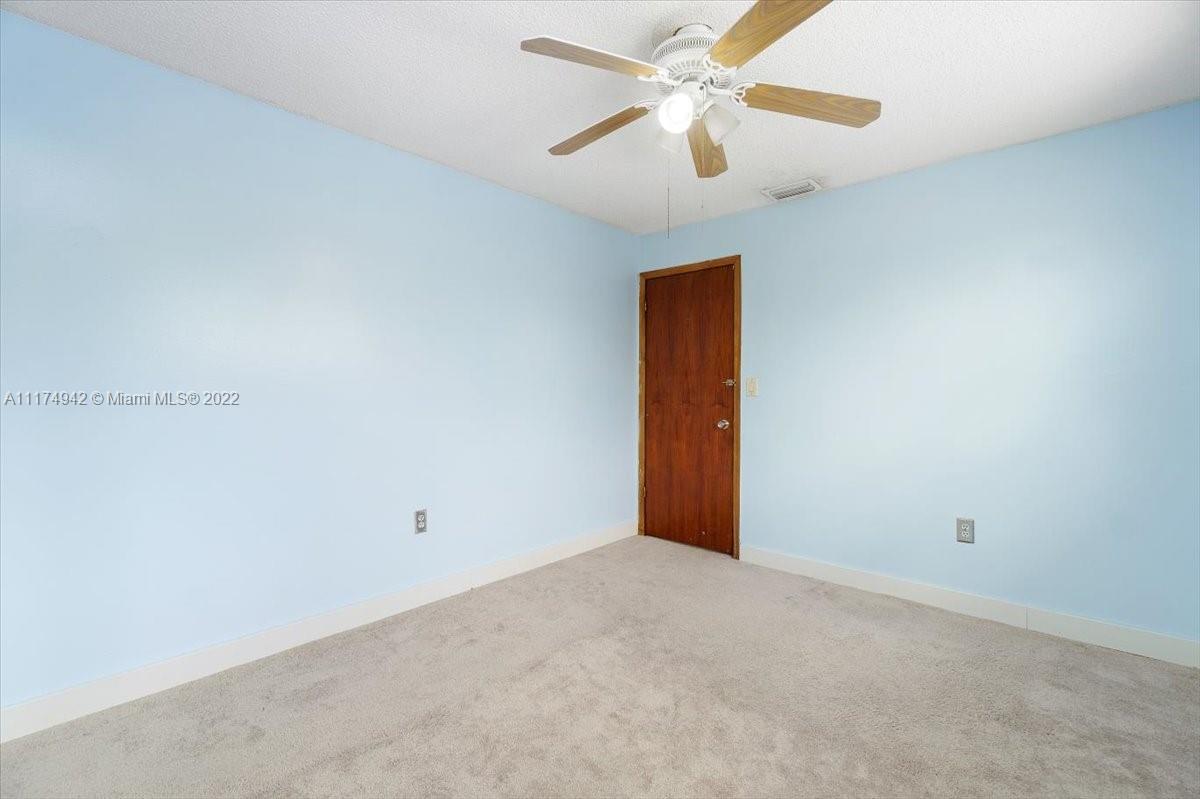 10975 Southwest 38th Terrace Miami, FL 33165 - Photo 13 of 21 an empty room with closet and a ceiling fan