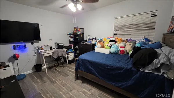 a bedroom with furniture and a flat screen tv