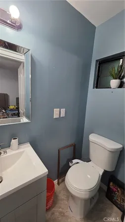a white toilet sitting next to a bathroom sink