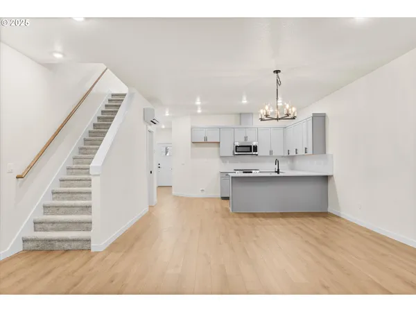 a view of hallway with wooden floor