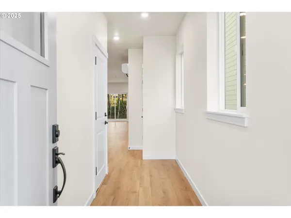 a view of an entryway with wooden floor