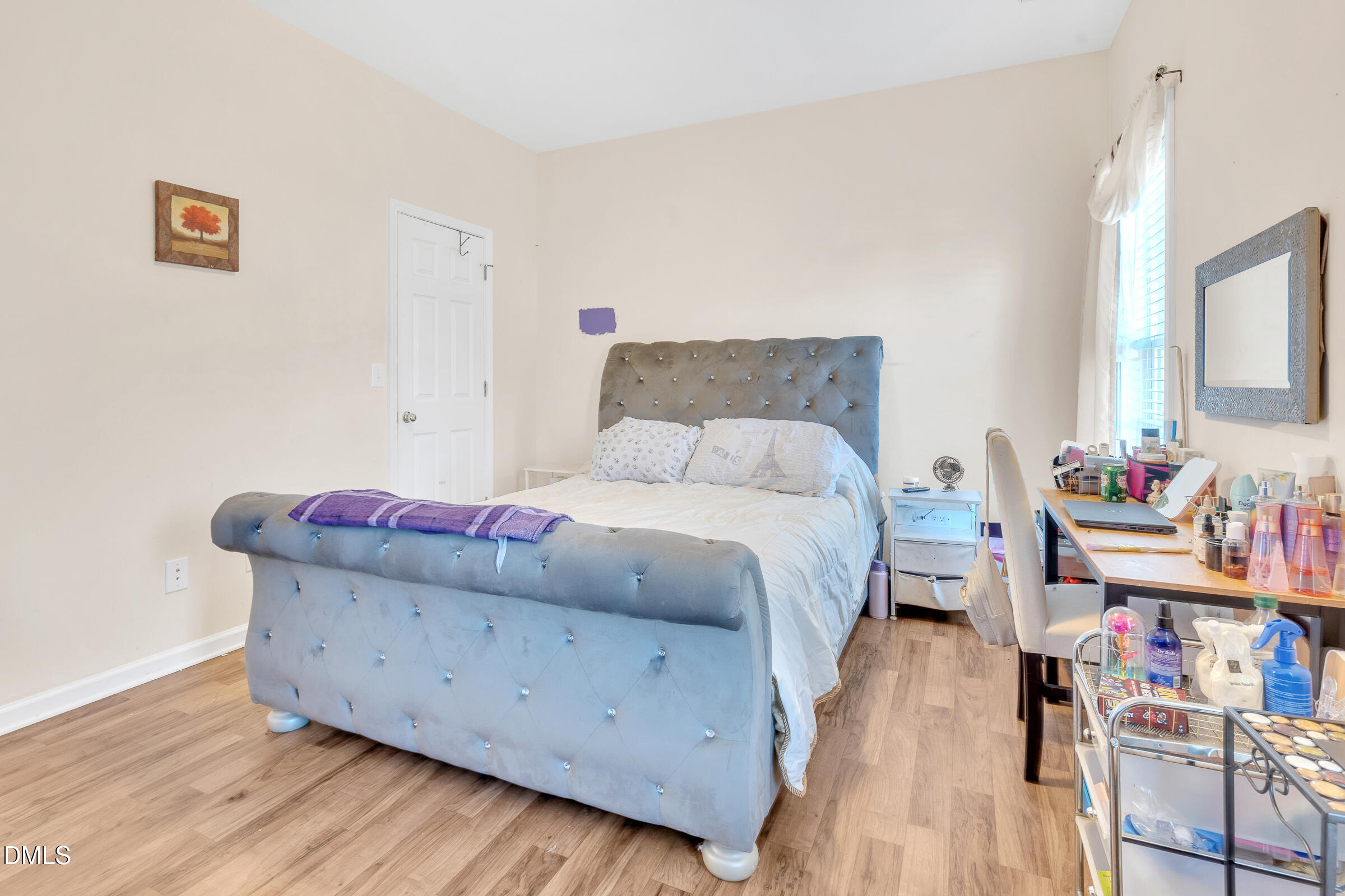 904 East Jones Street Raleigh, NC 27601 - Photo 11 of 21 a bedroom with a bed and wooden floor