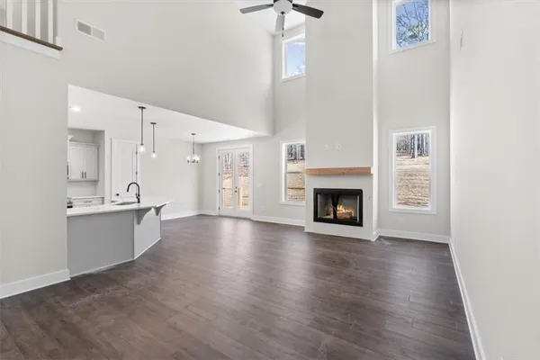 a view of a kitchen with a sink a fireplace and a window