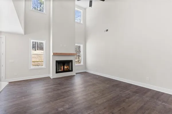 a view of a kitchen with wooden floor and windows