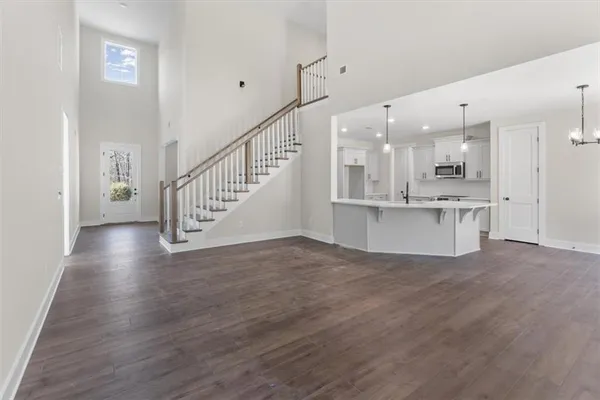 a view of kitchen with stainless steel appliances granite countertop cabinets and wooden floor