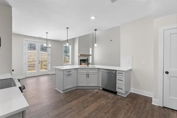 a large kitchen with stainless steel appliances granite countertop a sink and stove top oven