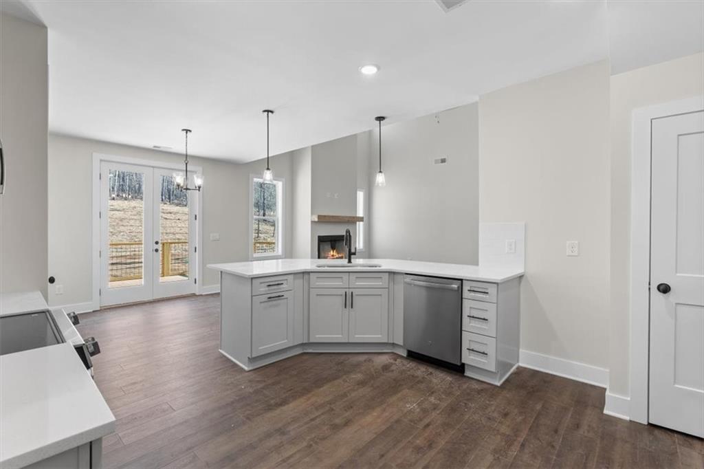14 Everwood Court Rome, GA 30161 - Photo 17 of 54 a large white kitchen with a window wooden floor and stainless steel appliances
