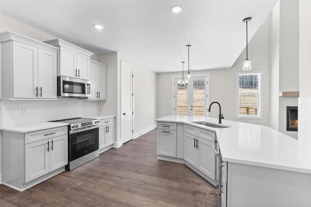 14 Everwood Court Rome, GA 30161 - Photo 18 of 54 a large kitchen with stainless steel appliances granite countertop a sink and stove top oven