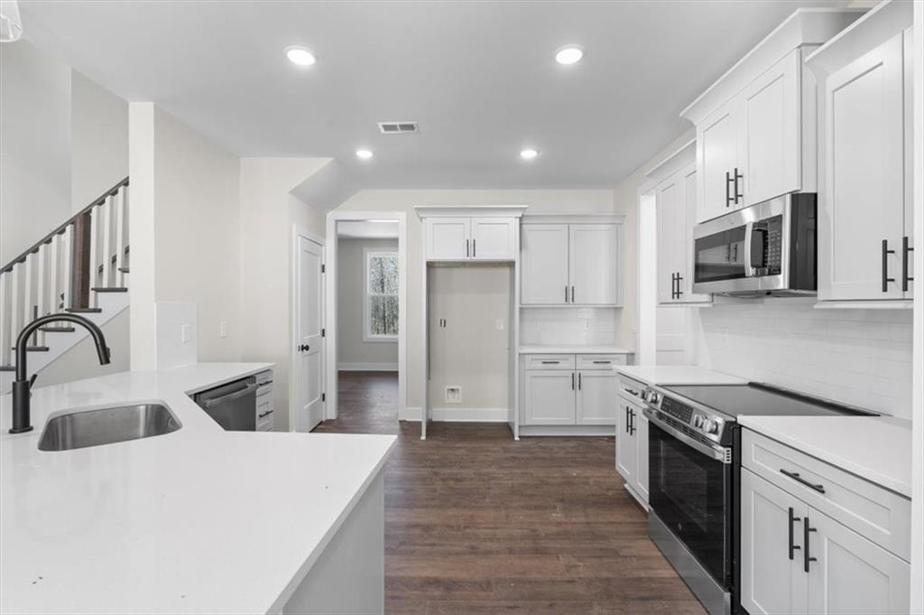 14 Everwood Court Rome, GA 30161 - Photo 19 of 54 a kitchen with kitchen island a sink appliances and cabinets