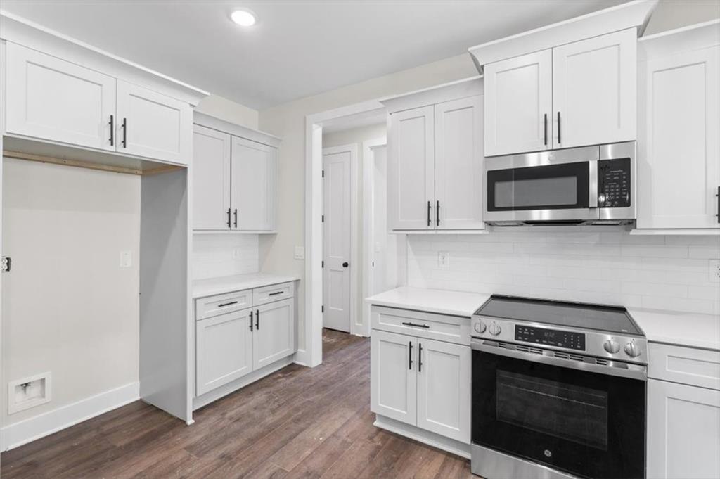 14 Everwood Court Rome, GA 30161 - Photo 20 of 54 a kitchen with stainless steel appliances white cabinets and a stove a oven with wooden floor