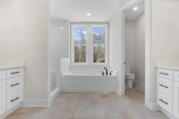 a white toilet sitting next to a white sink