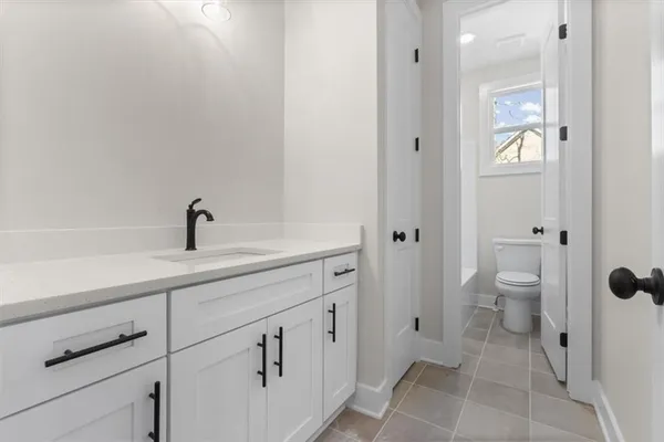 a white toilet sitting next to a bath tub