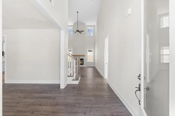 a view of a hallway with wooden floor and staircase