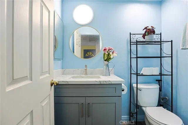 a bathroom with a toilet sink and mirror