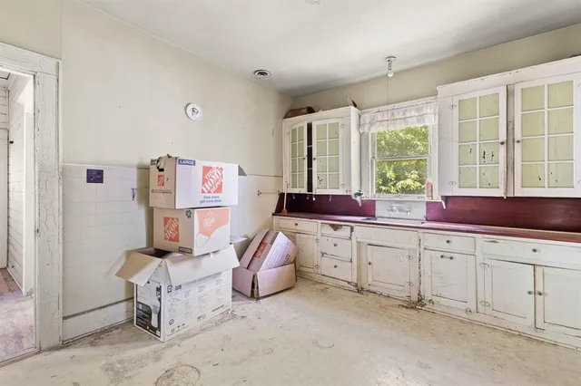 a kitchen with sink refrigerator and window