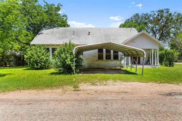 a front view of a house with a yard and porch