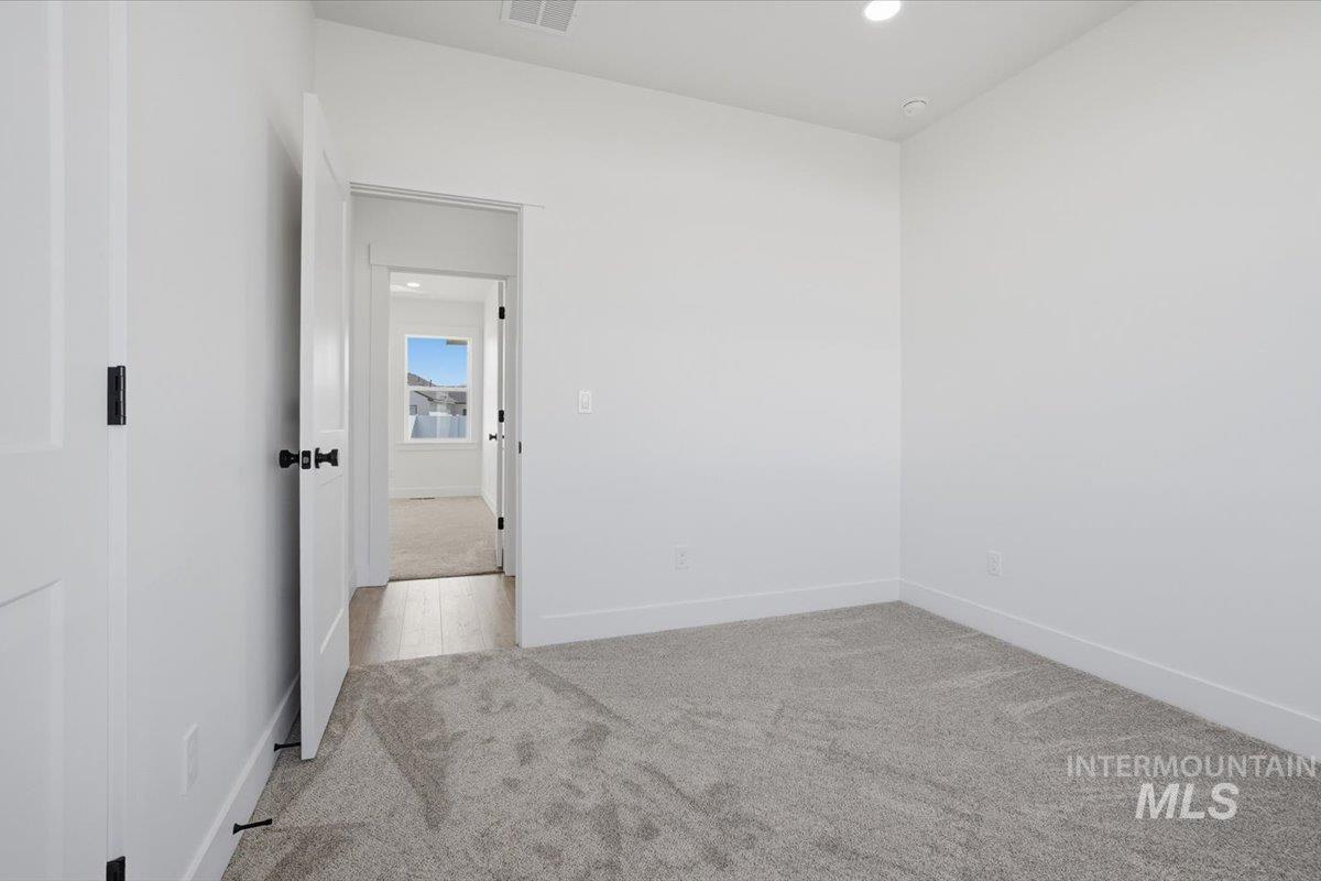 2175 Austin Way Fruitland, ID 83619 - Photo 20 of 30 Empty room with light carpet and recessed lighting
