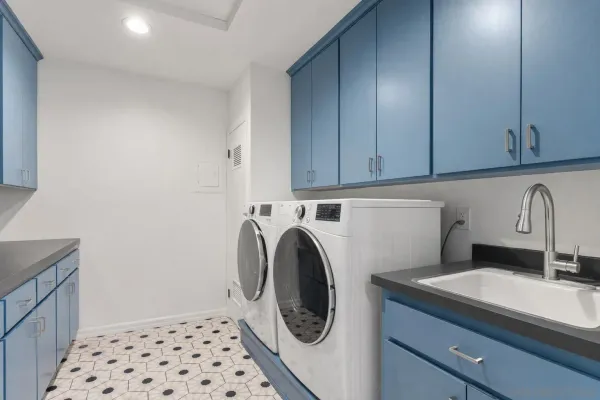 a kitchen with stainless steel appliances granite countertop a stove top oven a sink a dining table and chairs