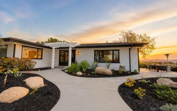 a front view of a house with a garden and porch