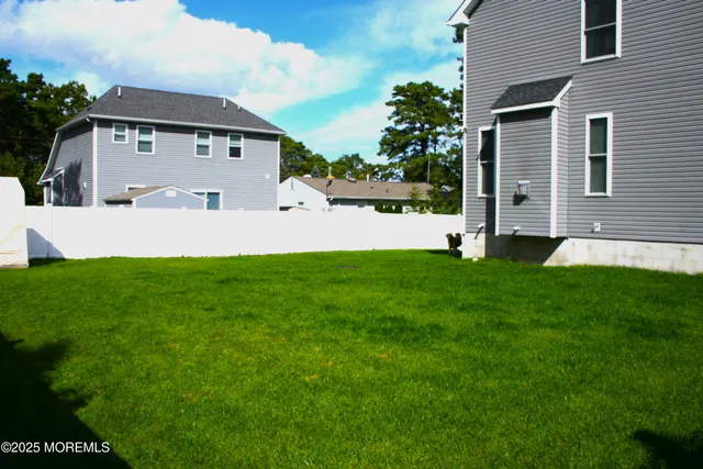 a front view of a house with a garden and yard