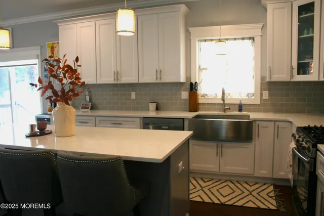 a kitchen that has a sink and a stove in it