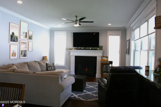 a living room with furniture a flat screen tv and a fireplace
