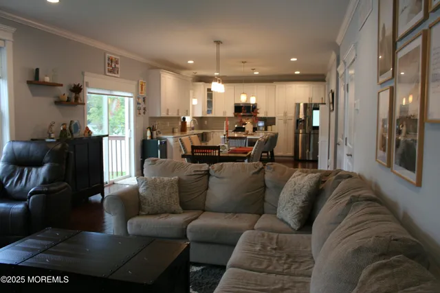 a living room with furniture and a chandelier