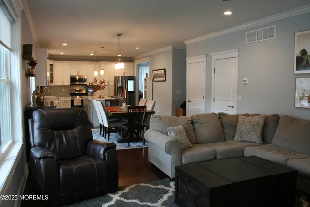 a living room with furniture and a chandelier