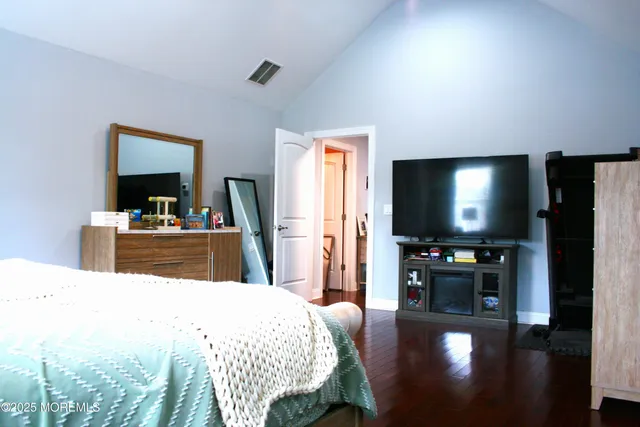 a bathroom with a granite countertop sink a toilet and a mirror