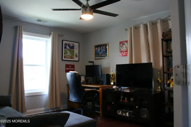 a living room with furniture a wine shelf and a closet
