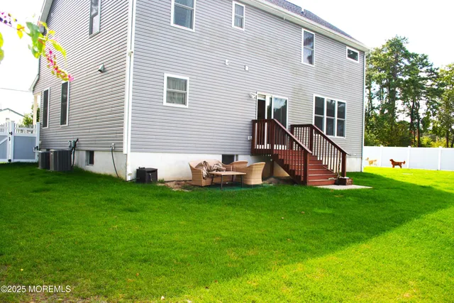 a view of a house with a backyard and a table