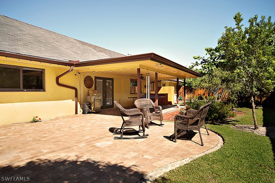 944 Robalo Drive Fort Myers, FL 33919 - Photo 13 of 14 a view of a swimming pool with lawn chairs and plants
