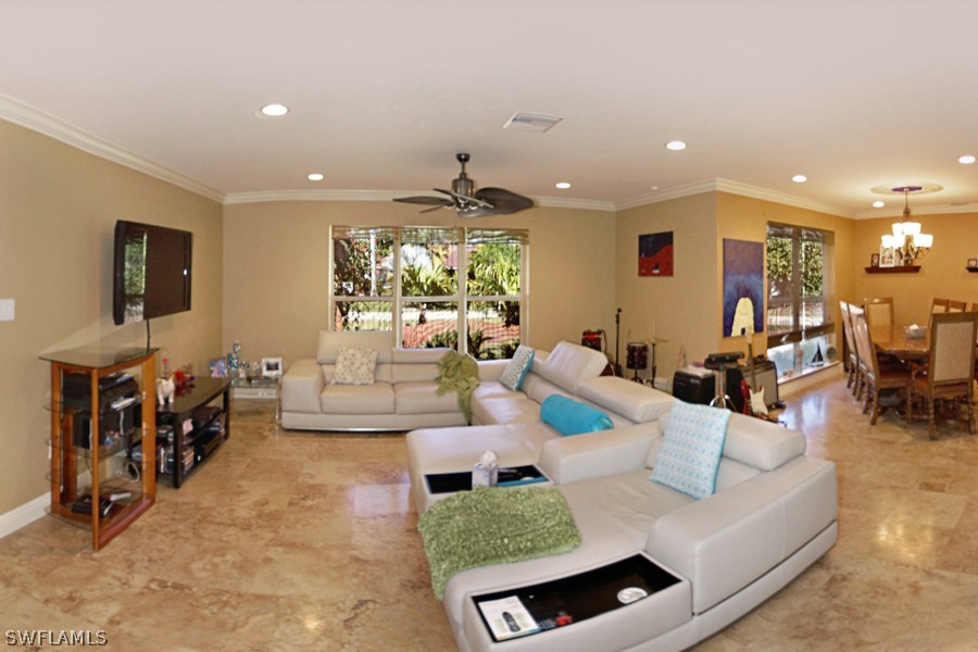 944 Robalo Drive Fort Myers, FL 33919 - Photo 2 of 14 a living room with furniture and a flat screen tv