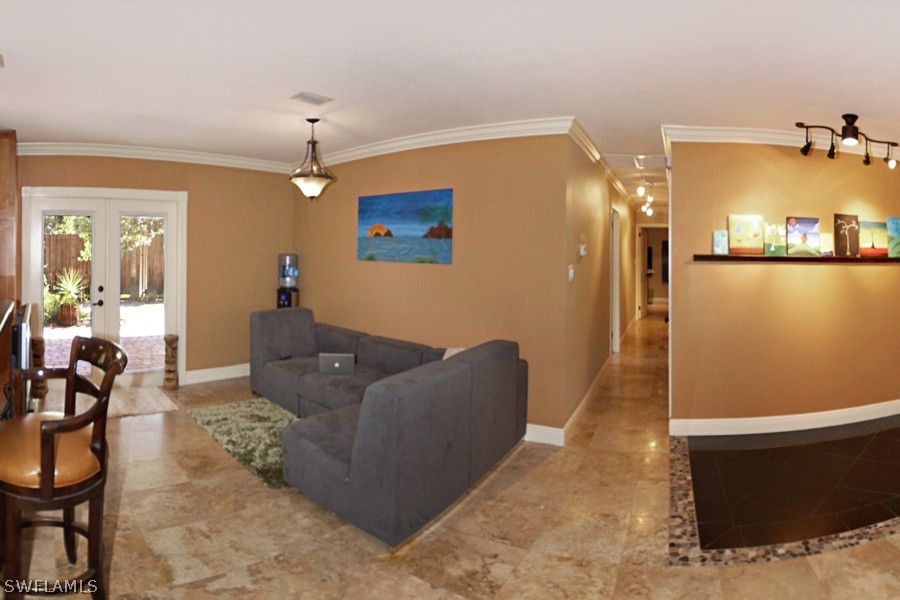 944 Robalo Drive Fort Myers, FL 33919 - Photo 3 of 14 a living room with furniture and a chandelier