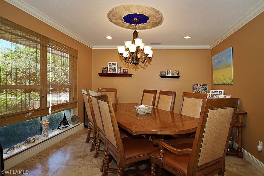944 Robalo Drive Fort Myers, FL 33919 - Photo 4 of 14 a view of a dining room with furniture a chandelier and wooden floor