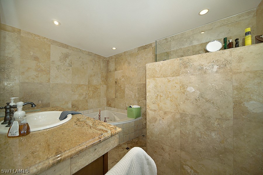 944 Robalo Drive Fort Myers, FL 33919 - Photo 7 of 14 a bathroom with a granite countertop sink a toilet and bathtub