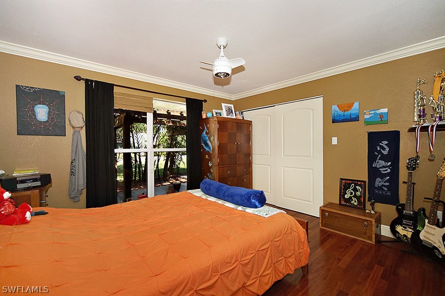 944 Robalo Drive Fort Myers, FL 33919 - Photo 9 of 14 a bed room with a bed mirror and a window