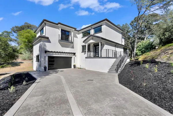 a front view of a house with a yard and garage