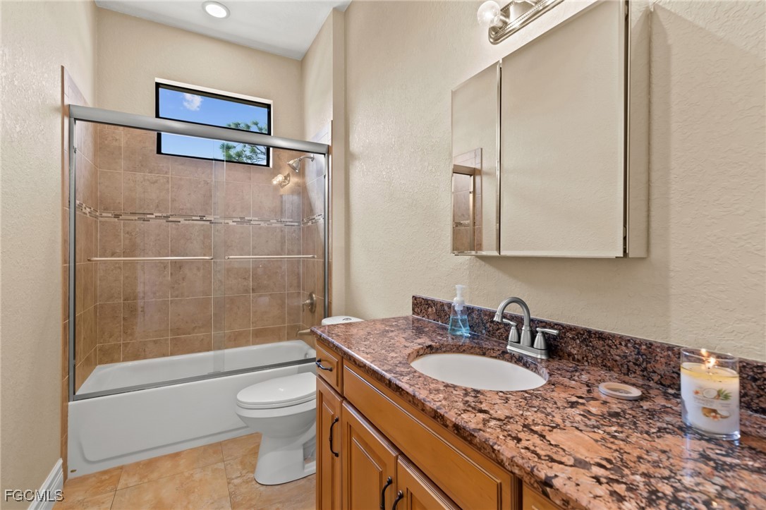 6057 Calusa Rdg Trail Bokeelia, FL 33922 - Photo 24 of 45 a bathroom with a granite countertop sink toilet and shower