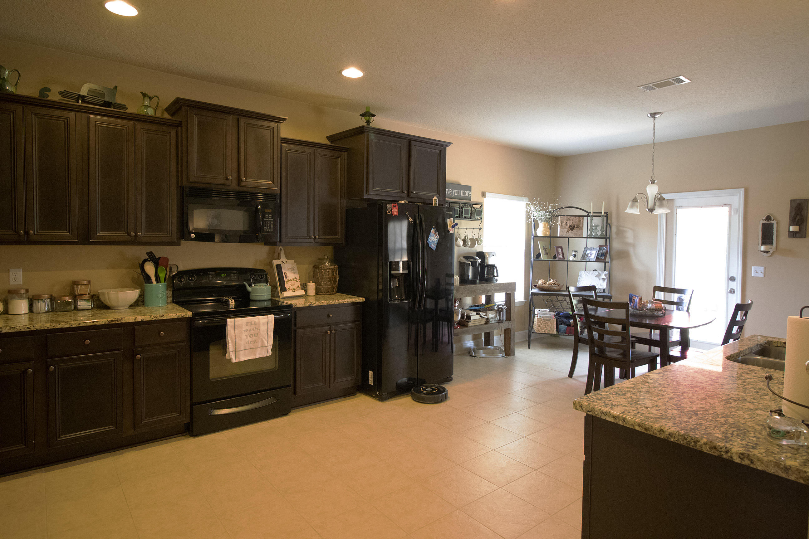 206 Mango Lane Freeport, FL 32439 - Photo 18 of 45 a kitchen with granite countertop a refrigerator a stove a sink a dining table and chairs