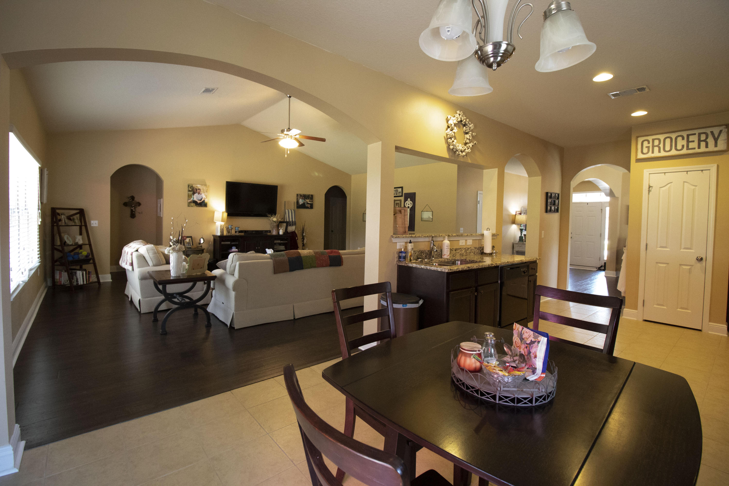 206 Mango Lane Freeport, FL 32439 - Photo 20 of 45 a living room with furniture kitchen view and a chandelier